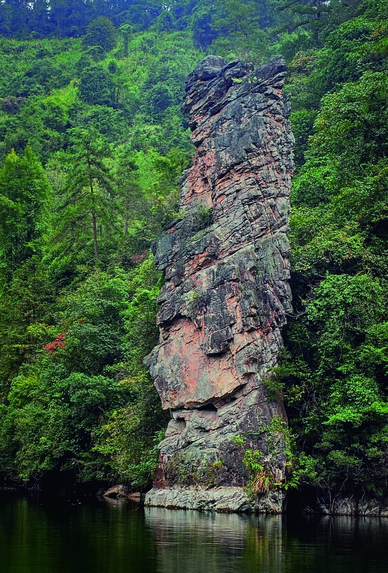 Official Tour Guide Manual photograph of the Baofeng Goddess pillar beside the lake