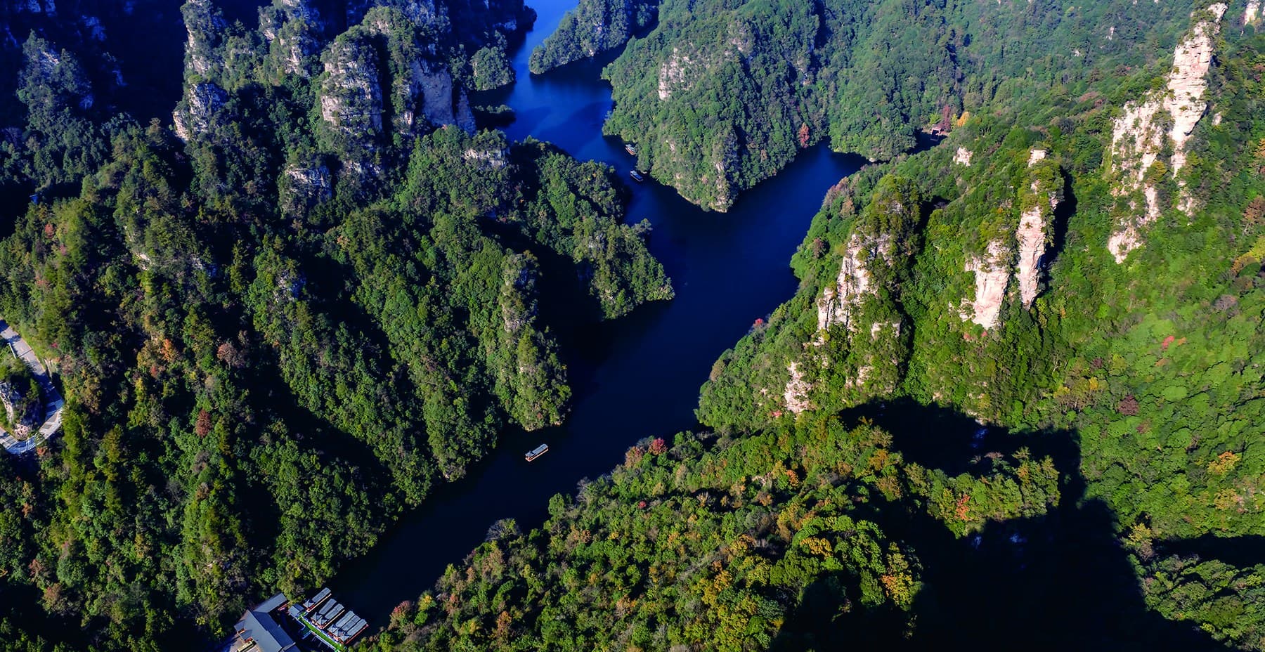 Official aerial photograph of Baofeng Lake among forested sandstone peaks
