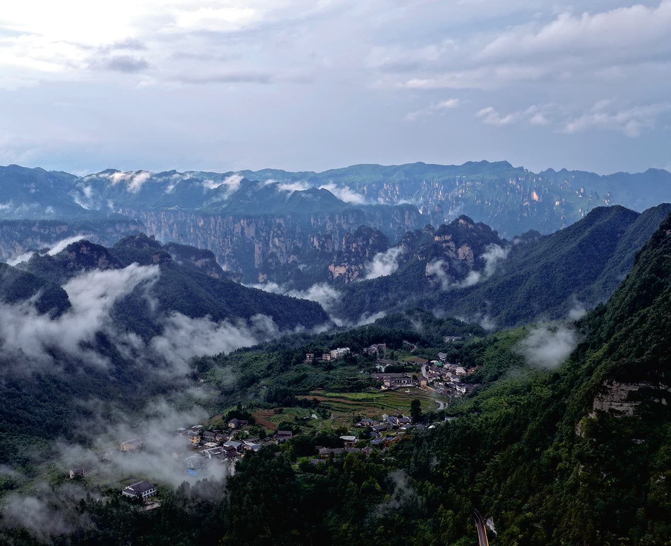 Longweiba Community below misty sandstone peak forests
