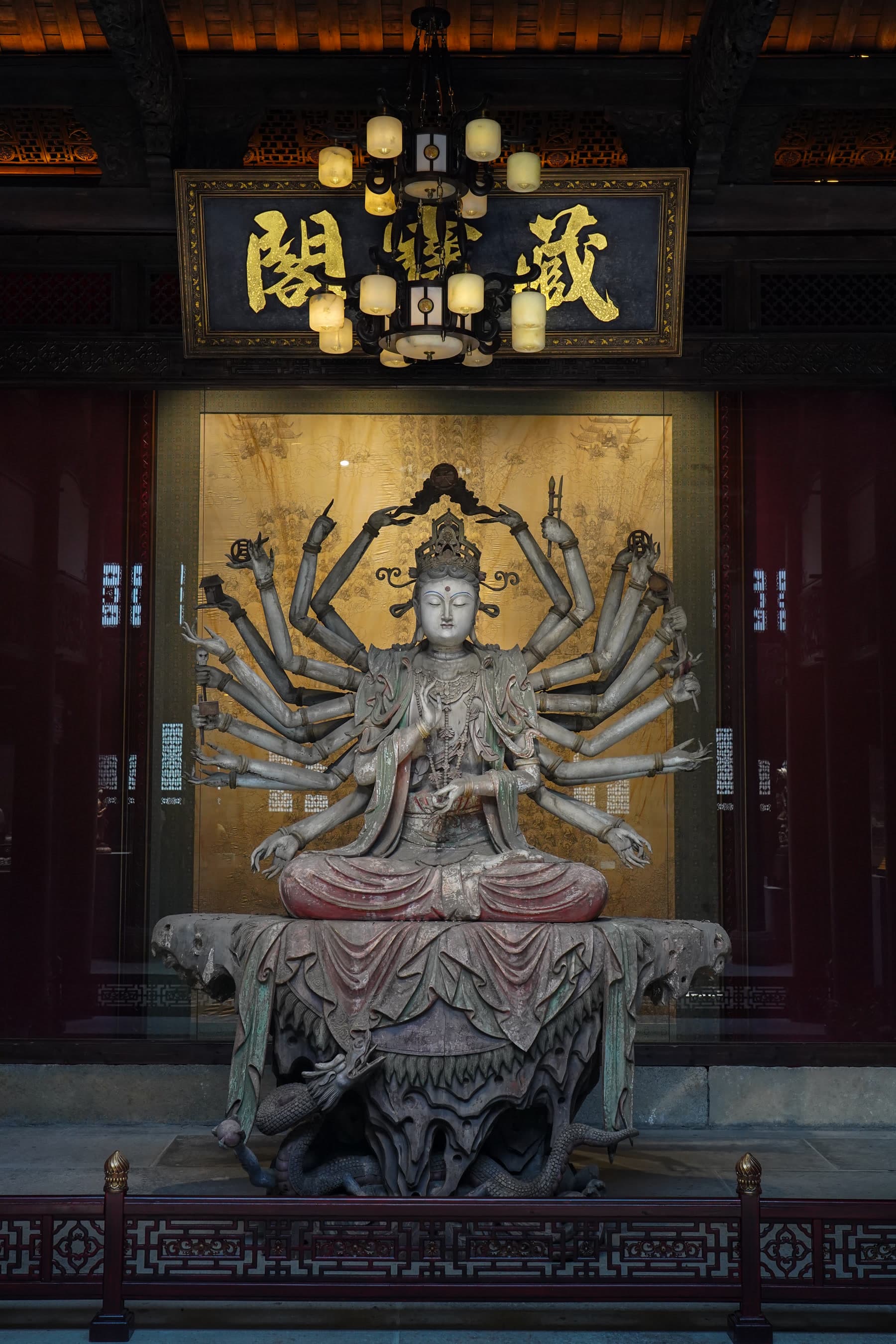 Multi-armed sculpture displayed in an indoor Xiangxifu gallery