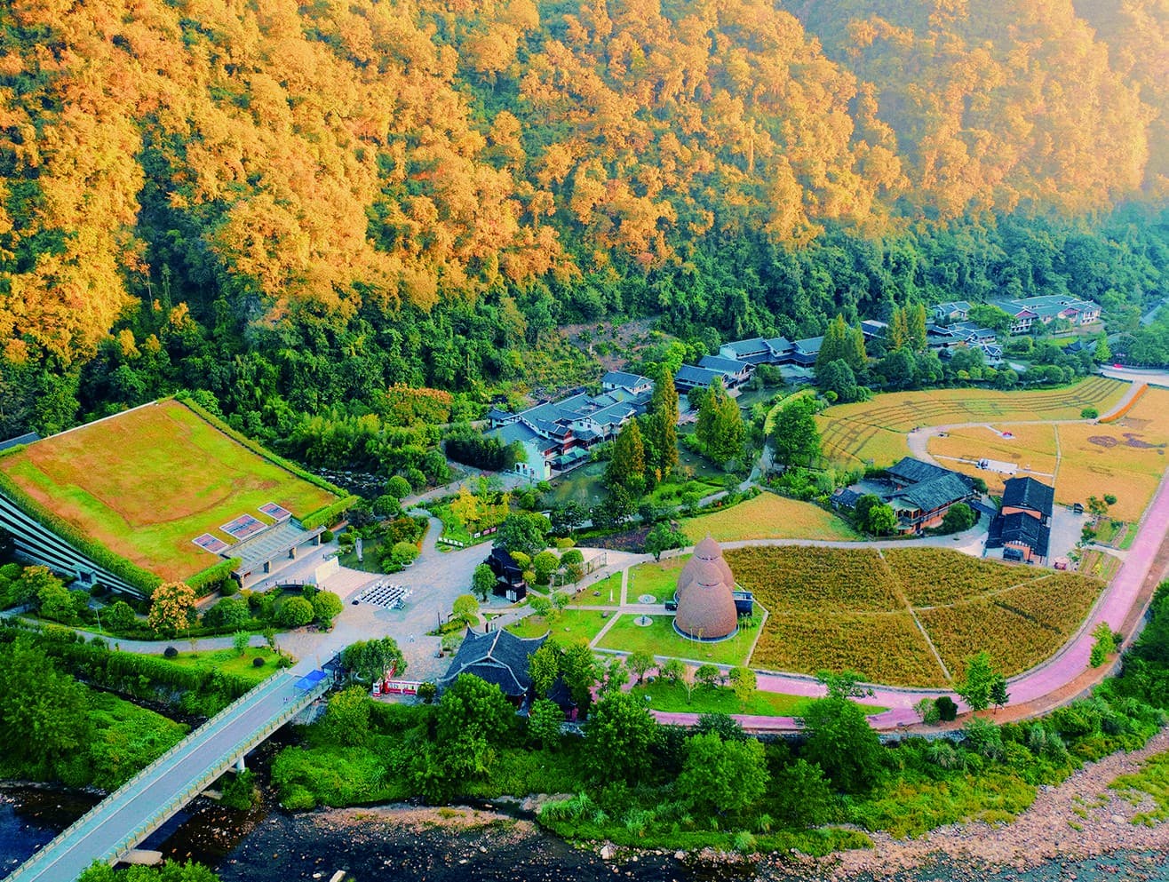 Aerial view of the Yellow Dragon Cave exterior and surrounding valley