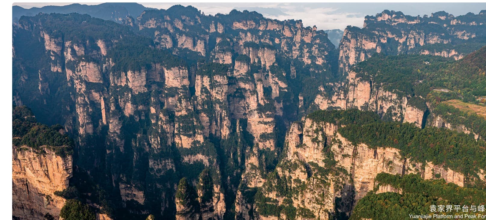 Layered Yuanjiajie sandstone pillars from the official Tour Guide Manual.