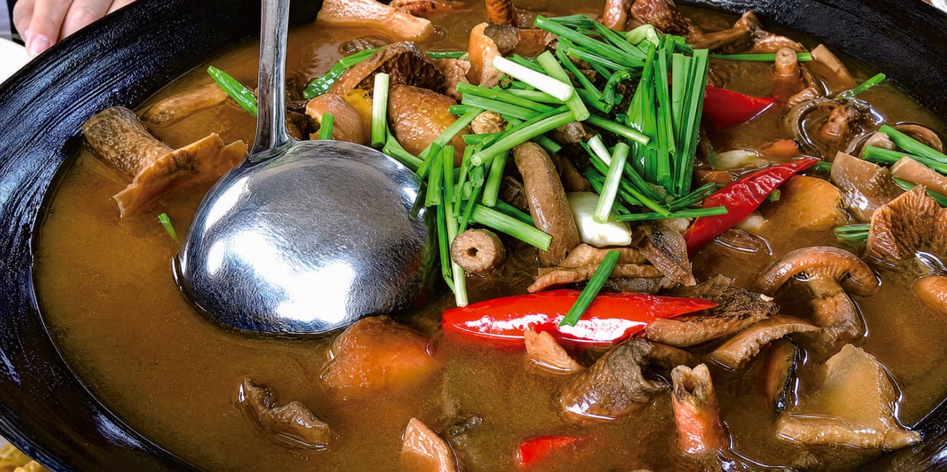 Cured meat stewed with saffron milk cap mushrooms in the official Tour Guide Manual.