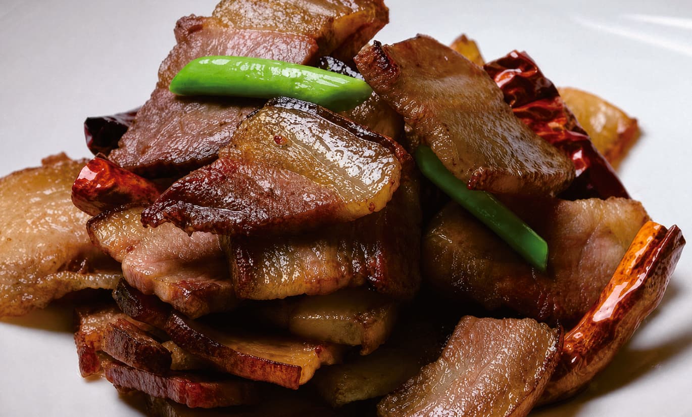 Tujia cured meat served with vegetables in the official Tour Guide Manual.