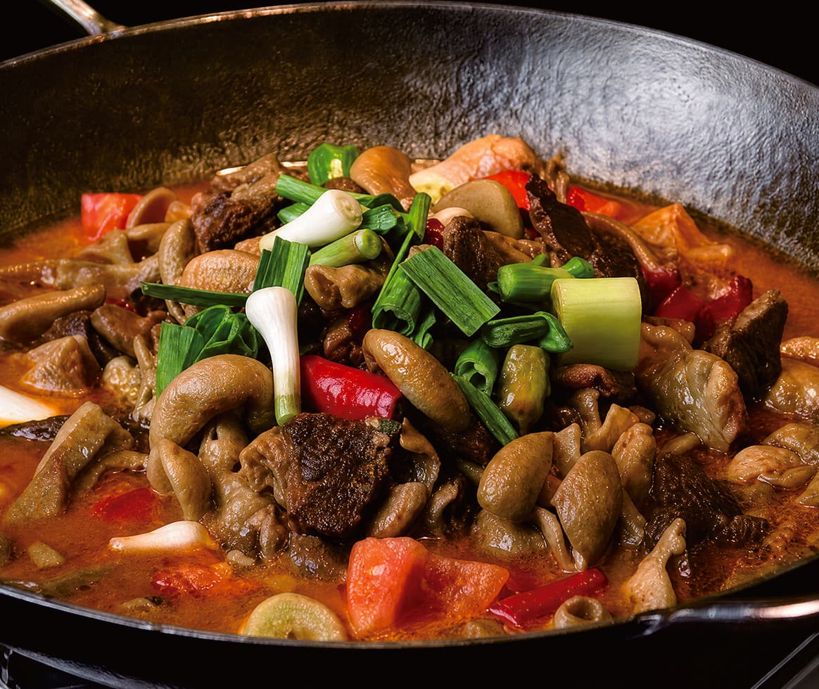 A traditional Tujia mixed dish presented in the official Tour Guide Manual.