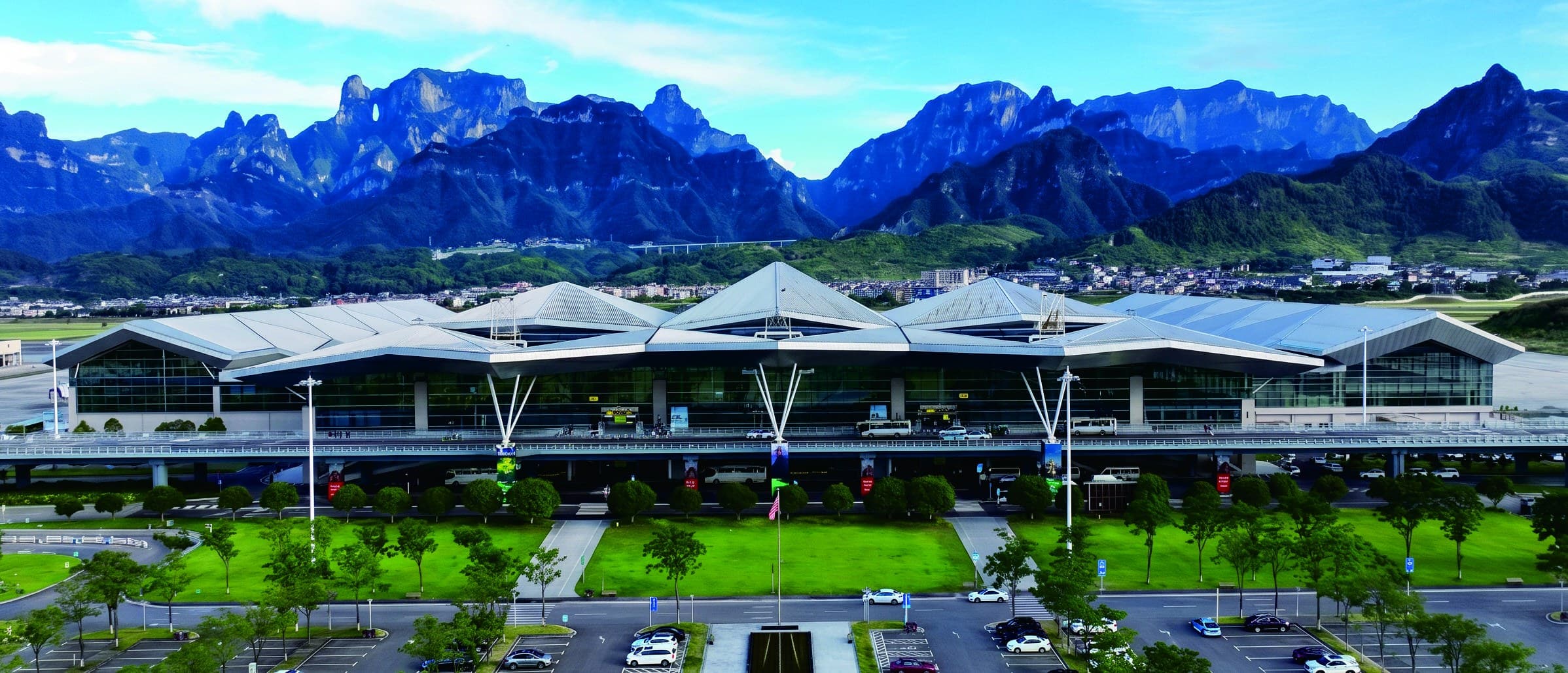 Zhangjiajie Hehua International Airport with Tianmen Mountain behind in the official Tour Guide Manual.