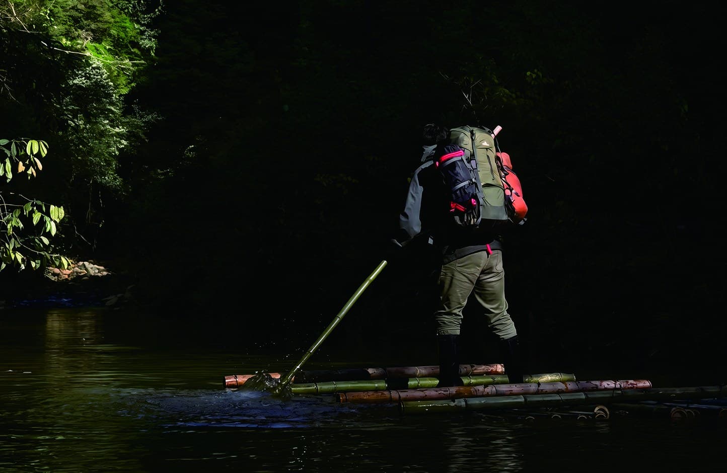 A traveller crossing a forest stream on a bamboo raft in the official Tour Guide Manual.
