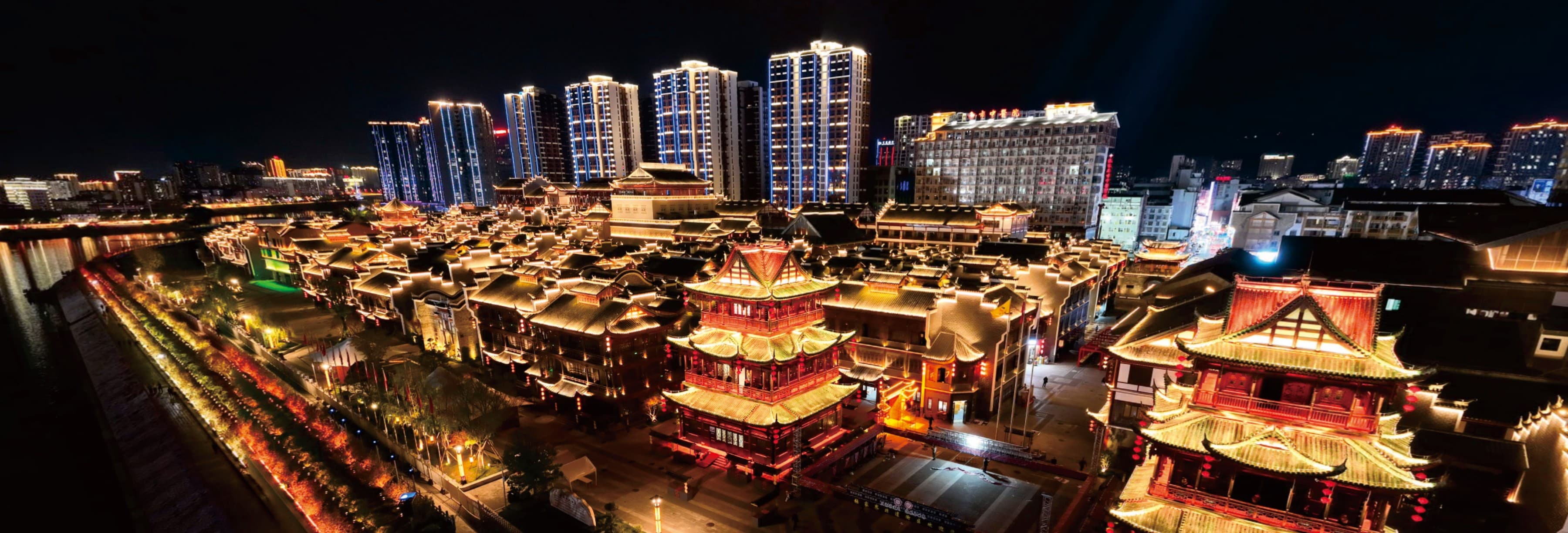 Zhangjiajie city illuminated at night in the official Tour Guide Manual.
